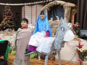 Anne Marie Amacher A young girl and boy portray Mary and Joseph during a posada at St. Mary Parish in Davenport Dec. 16. 