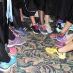 SAU grads lace up tennis shoes for classmate