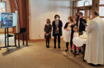 Deployed godmother participates in baptism online