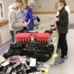 Students stuff ‘man’ bags, purses for homeless