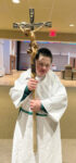 Carrying the cross with joy - Fifth-grade altar server with Down syndrome relishes his role