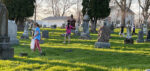 Youths ask questions during cemetery cleanup